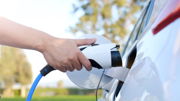 A person about to charge their electric vehicle.