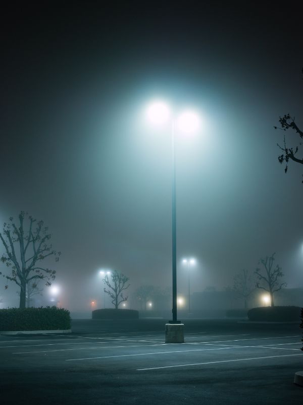 Parking lot lights on a misty night.