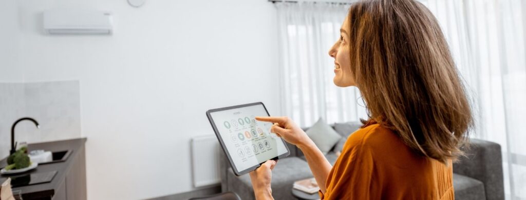 A woman checking her HVAC with her tablet. 