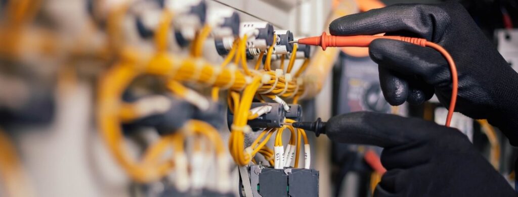 A technician checking the wires in a residential property.