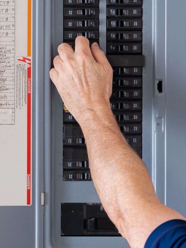 A technician working on an electrical panel.
